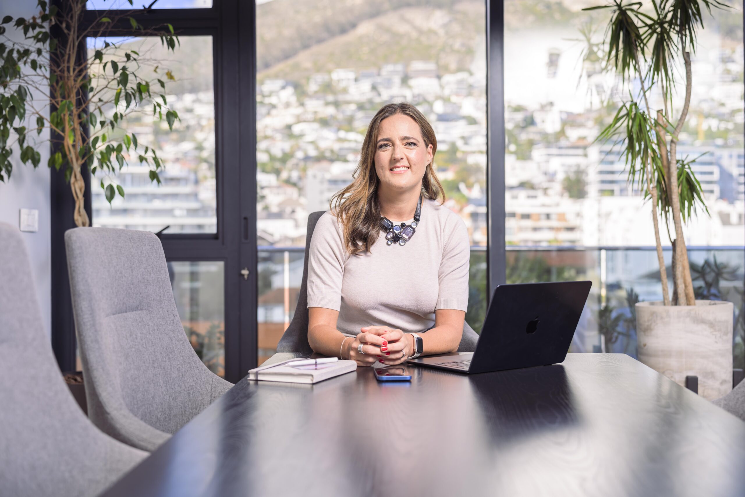 Professional woman working on a laptop with multiple projects and income streams, representing the concept of a portfolio career and career flexibility.